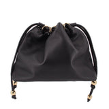 Black drawstring handle bag with gathered top and gold-tone cord details