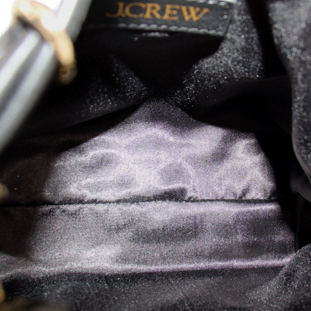 Black drawstring bag interior lining with J.CREW label and gathered seam
