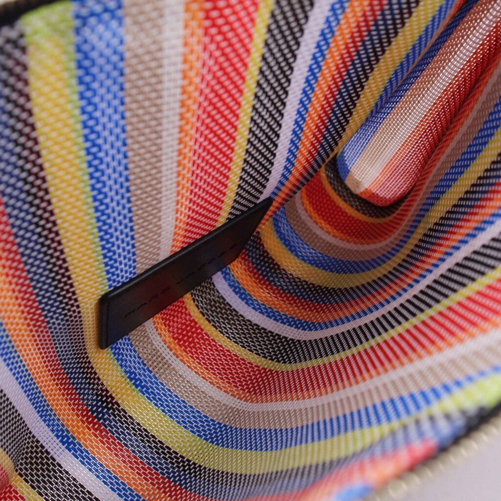 Close-up of multicolor striped mesh pouch with black trim and stitched edge
