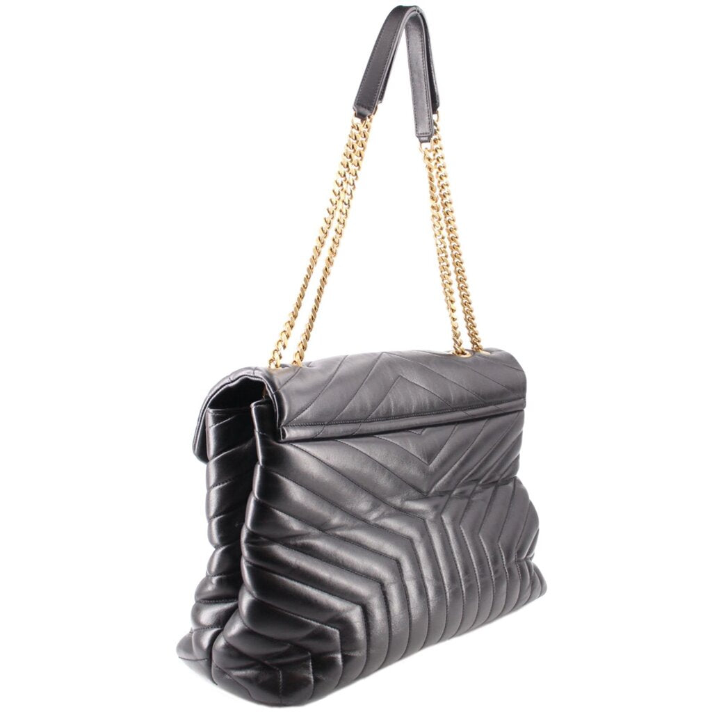 Black quilted shoulder bag with chain strap and YSL logo, angled side view