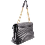 Black quilted shoulder bag with chain strap and YSL logo, angled side view