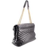 Black quilted shoulder bag with chain strap and YSL logo, angled side view