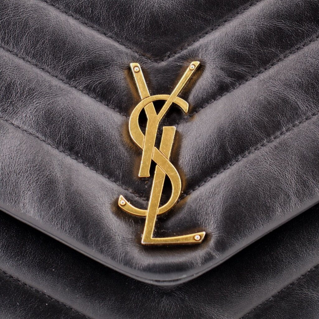 Gold-tone YSL logo on black quilted leather flap of shoulder bag