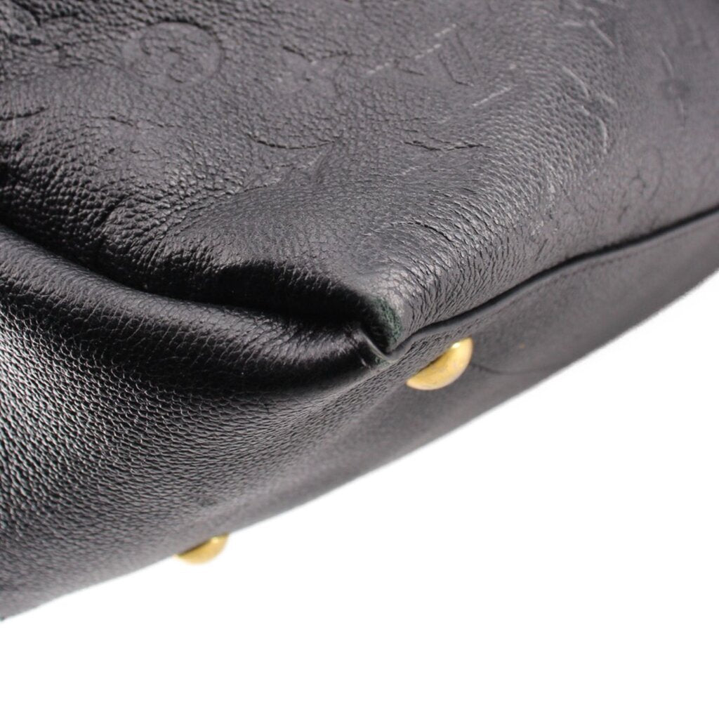 Black embossed hobo crossbody bag close-up with gold-tone stud foot