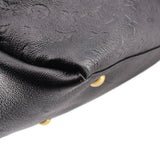 Black embossed hobo crossbody bag close-up with gold-tone stud foot