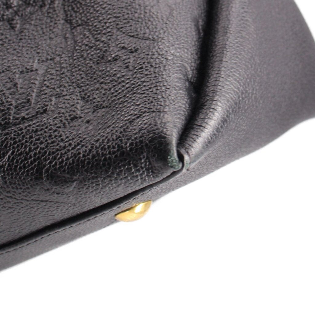 Black embossed hobo crossbody bag corner close-up with gold-tone stud