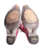 Underside view of mauve cowboy boots showing heel and printed brand sole