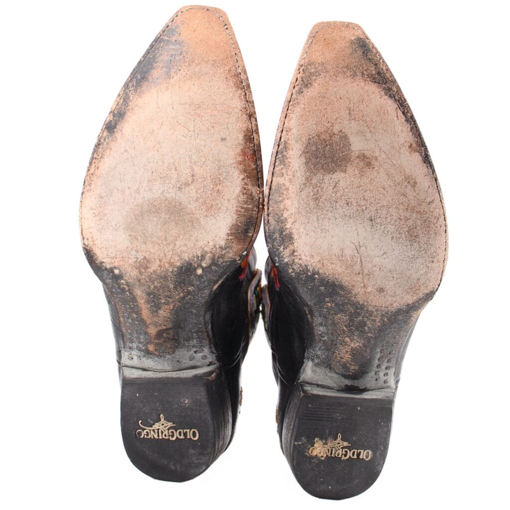 Women’s cowboy boot outsoles and heels in black with brown worn finish.