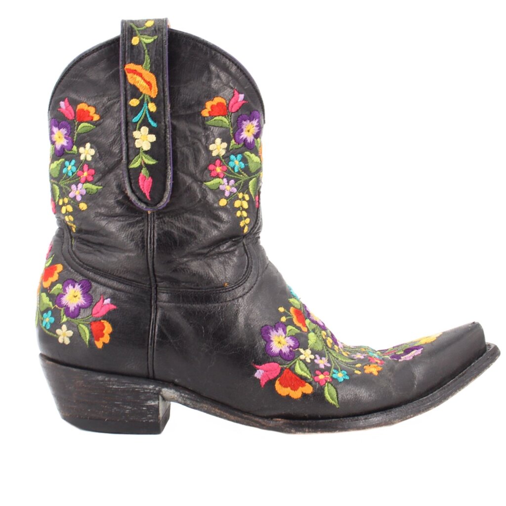 Black women’s cowboy boot with floral embroidery on shaft and instep, low heel.
