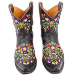 Pair of black women’s cowboy boots with vivid floral embroidery, pull-on, low heel.