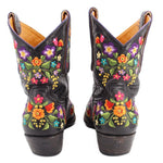 Women’s black cowboy boots with floral embroidery on back of shaft, low block heel.