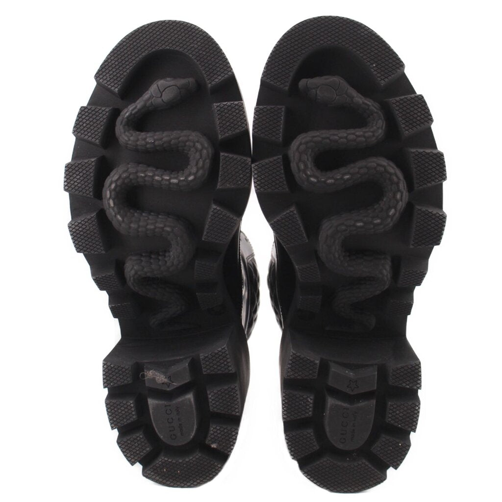 GUCCI platform boots, black rubber outsole with tread pattern, heel and toe views