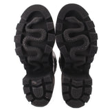GUCCI platform boots, black rubber outsole with tread pattern, heel and toe views