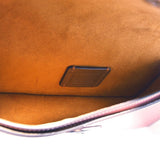 Interior of rose COACH crossbody bag lining with small leather brand patch