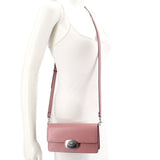 Rose small flap crossbody bag worn on model with adjustable shoulder strap