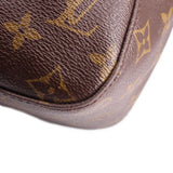 Louis Vuitton monogram shoulder bag corner close-up with leather trim and stitching