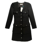Black long-sleeve dress with button front, flap pockets, and structured waist panels