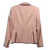 Back view of pink double-breasted blazer with burgundy-trimmed hem and shoulders