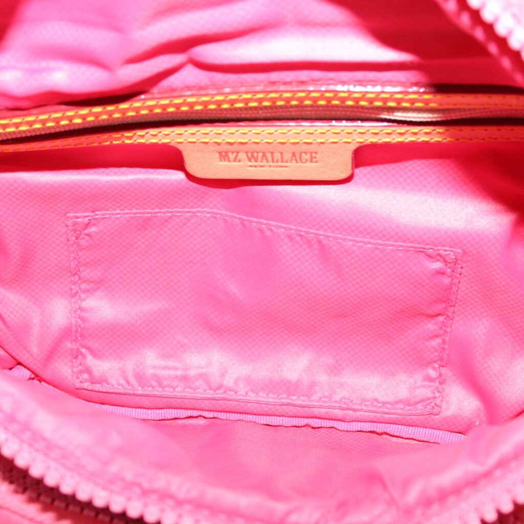 Pink interior of quilted sling belt bag with zip pocket and MY WALLACE tag
