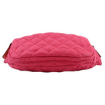 Pink quilted sling belt bag with rounded back panel and zipper ends