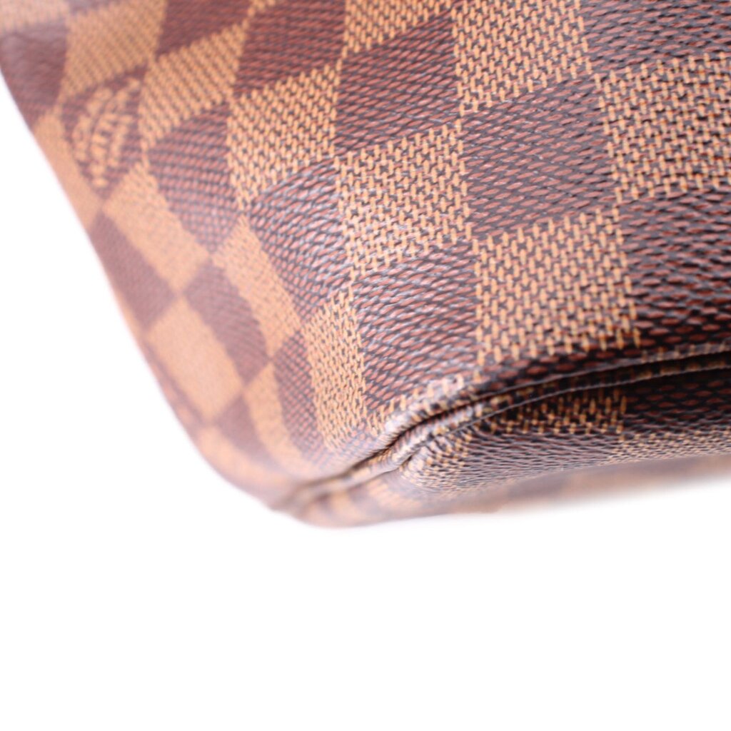 Louis Vuitton Damier Ebene tote bottom corner close-up with stitched rounded leather edge