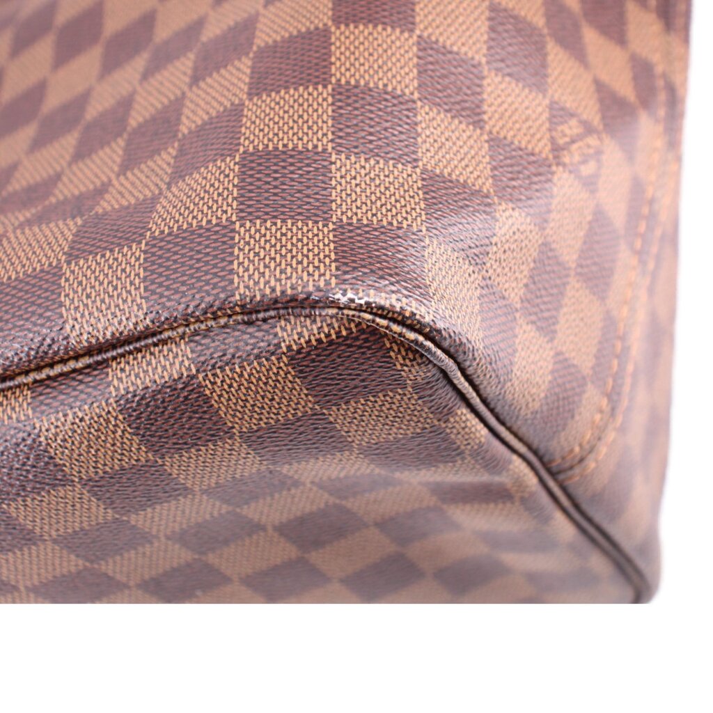 Louis Vuitton Damier Ebene tote corner close-up with stitched leather trim