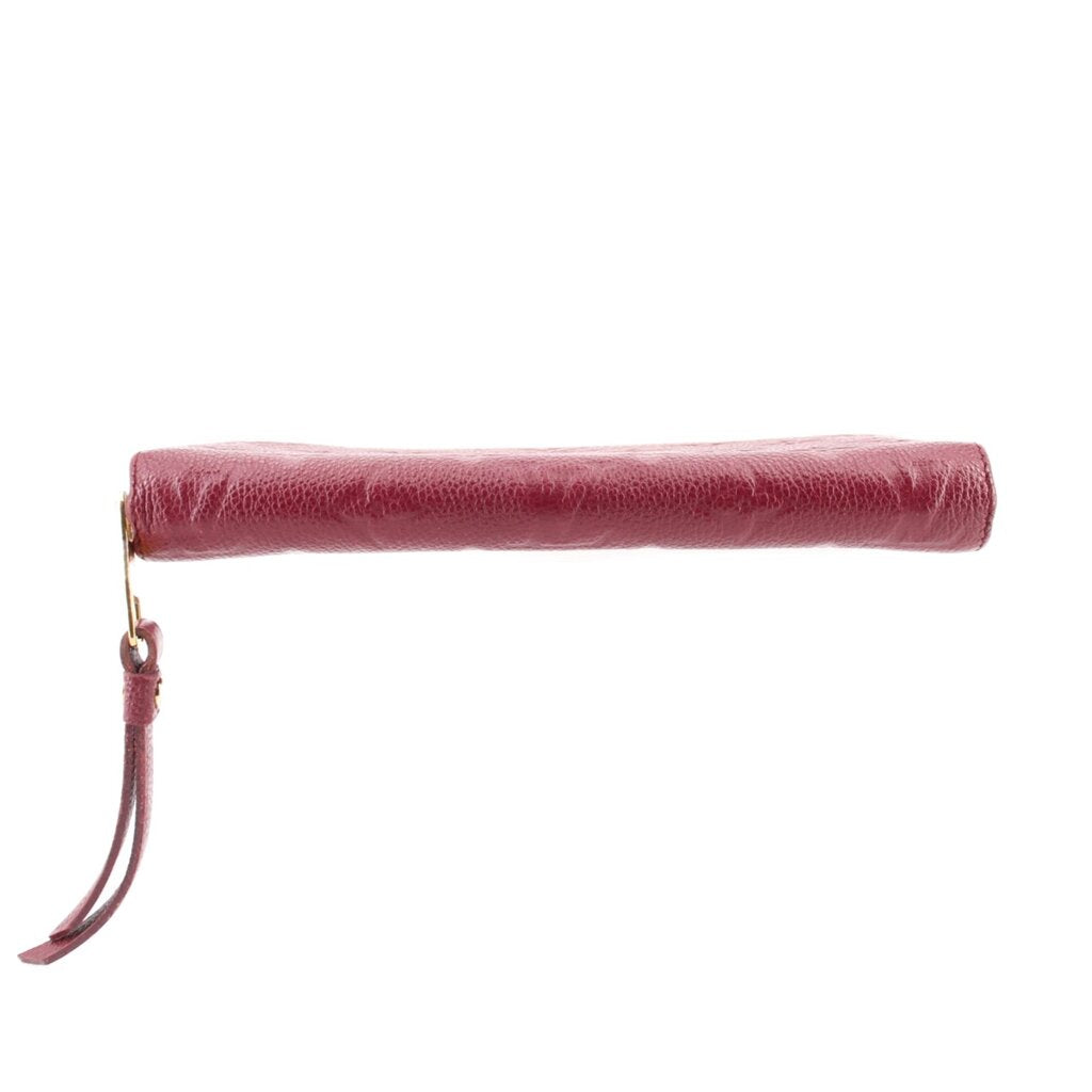 Empriente zip wallet with burgundy leather wrist strap and gold-tone zipper end.