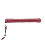 Empriente zip wallet with burgundy leather wrist strap and gold-tone zipper end.