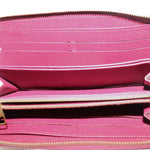 Zip wallet interior with pink lining, card slots, and gold-tone zipper track.