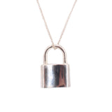 Close-up sterling silver padlock necklace pendant with arched top and reflective lock