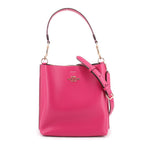 Coach Mollie bucket crossbody bag, fuchsia pebbled leather look with adjustable strap.