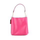 Coach Mollie bucket crossbody bag in fuchsia with curved top handles and wide opening.