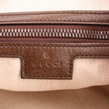 Brown leather trim and zipper hardware inside a GG canvas shoulder bag