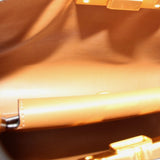 Close-up of gold-toned hardware on black satchel interior