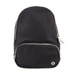 Black sling bag with rounded top and front zipper pocket