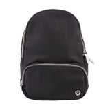 Black sling bag with rounded top and front zipper pocket