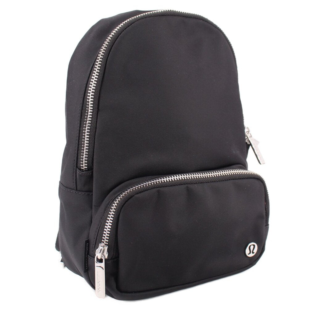 Black mini sling backpack with front zip pocket and silver-tone zipper pulls