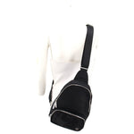 Black mini sling bag worn with adjustable shoulder strap