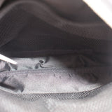 Interior view of black sling bag with mesh-lined pocket