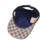 Inside view of beige GG monogram baseball cap with navy lining and size tag