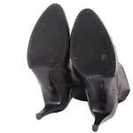 Knee-high leather boots with textured soles and stiletto heels, black