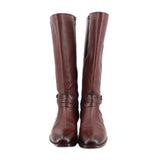 Pair of brown leather knee-high boots with zip closures and buckle straps