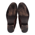 Shoe insoles with FRYE logo on dark brown leather boot soles