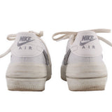 NIKE Air Force 1 PLT.AF.ORM sneakers, white leather, heel view with 'NIKE Air' text