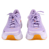 Pair of purple running sneakers, orange heel panels, lavender laces