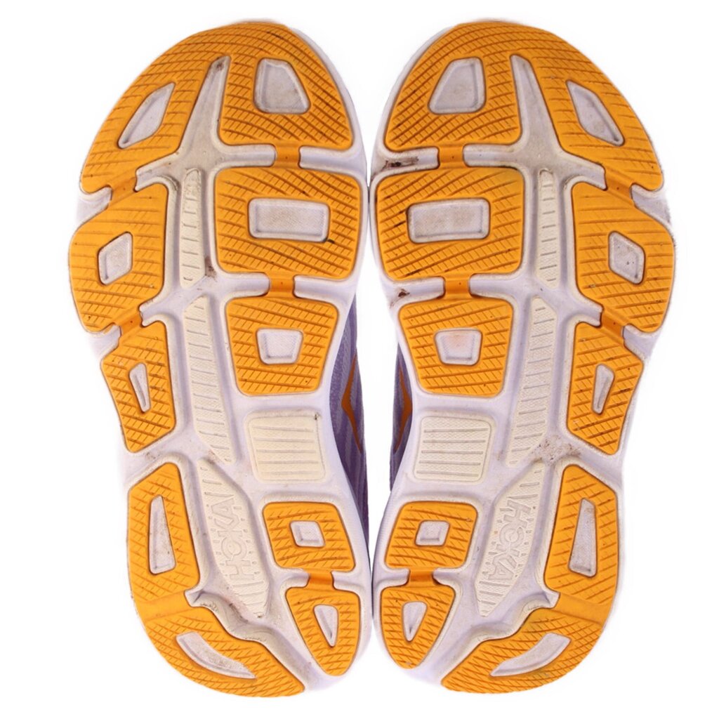 Purple sneakers outsole with white and orange rubber traction tread