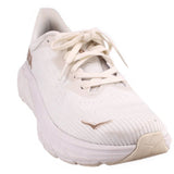 White knit lace-up running sneakers with tan HOKA logo and cushioned sole