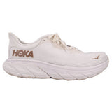 White lace-up running sneakers with HOKA logo on side and thick ribbed sole