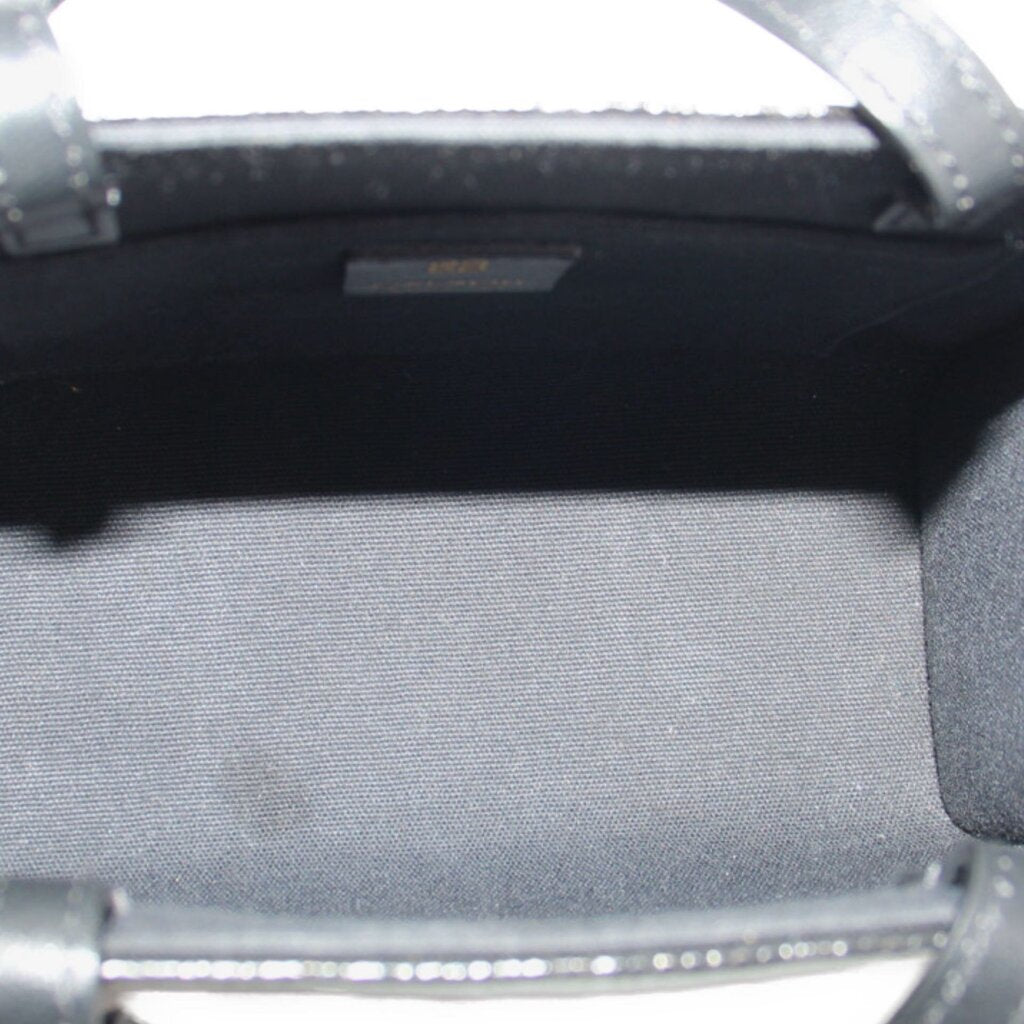 Black tote crossbody interior lining with top edge and metal clasp bar