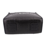 Black tote crossbody with embossed pattern and square patch detail on back